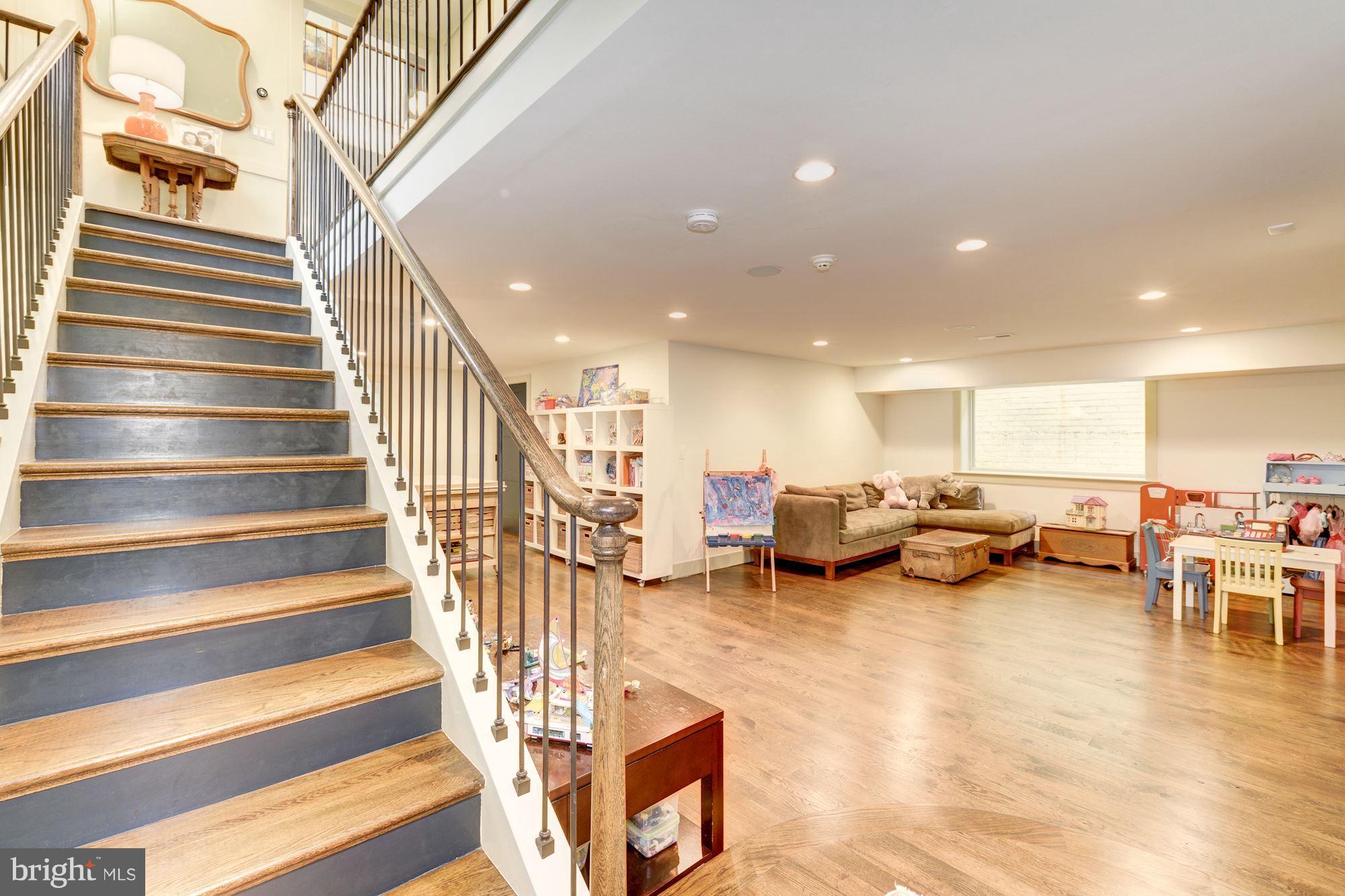 6134 Nevada Avenue Chevy Chase, MD 20815 - Photo 26 of 30 a living room with furniture and a chandelier