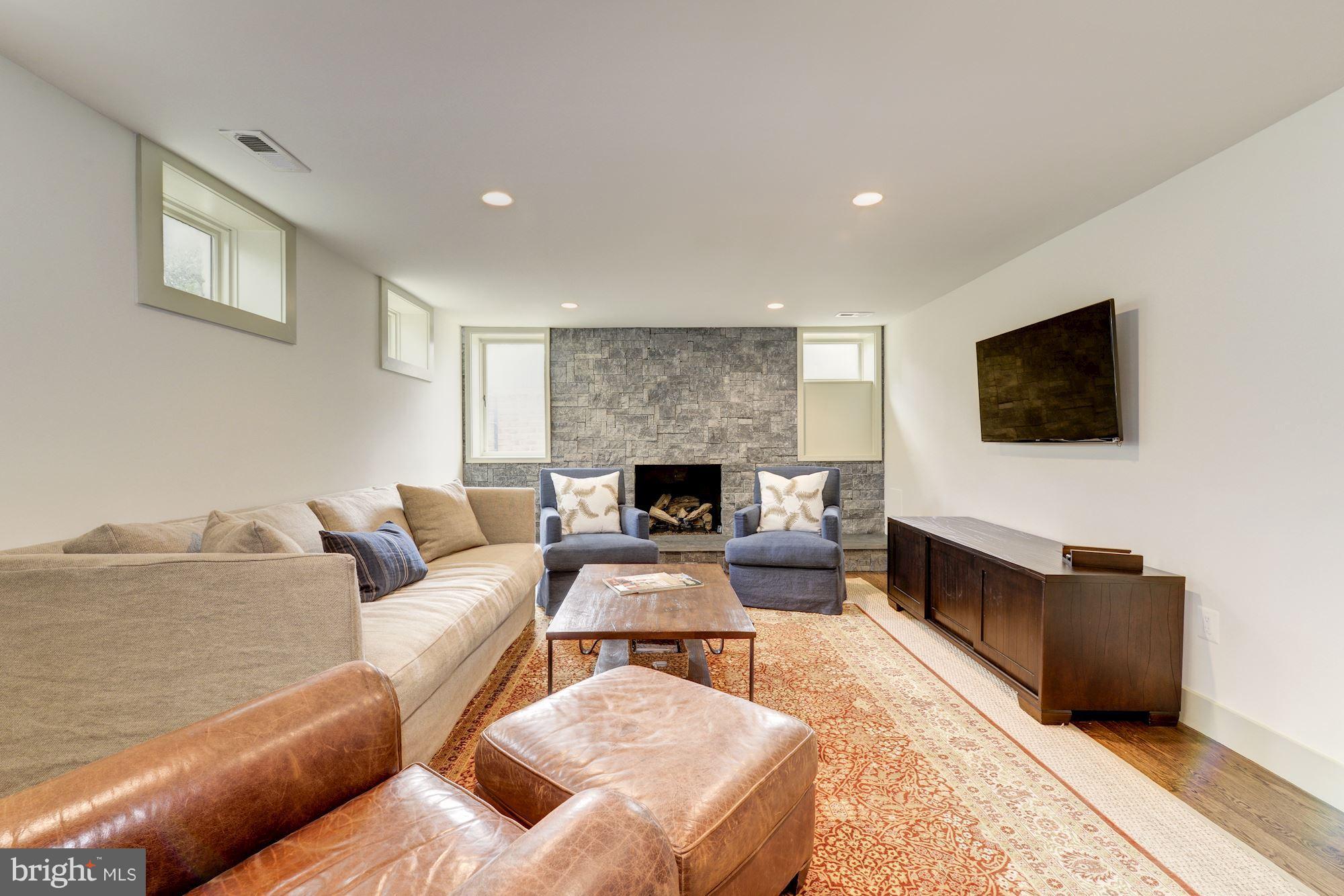 6134 Nevada Avenue Chevy Chase, MD 20815 - Photo 27 of 30 a living room with furniture and a flat screen tv