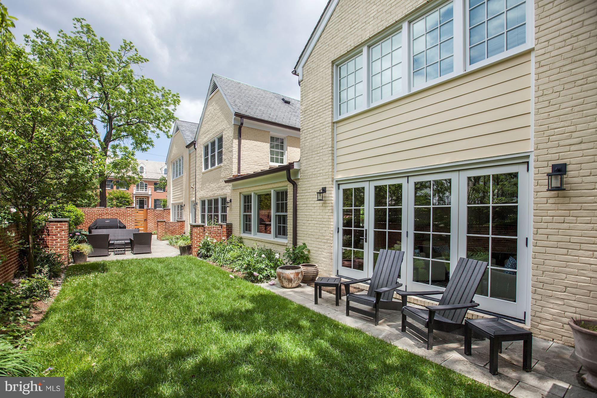 6134 Nevada Avenue Chevy Chase, MD 20815 - Photo 28 of 30 a view of a house with backyard sitting area and garden