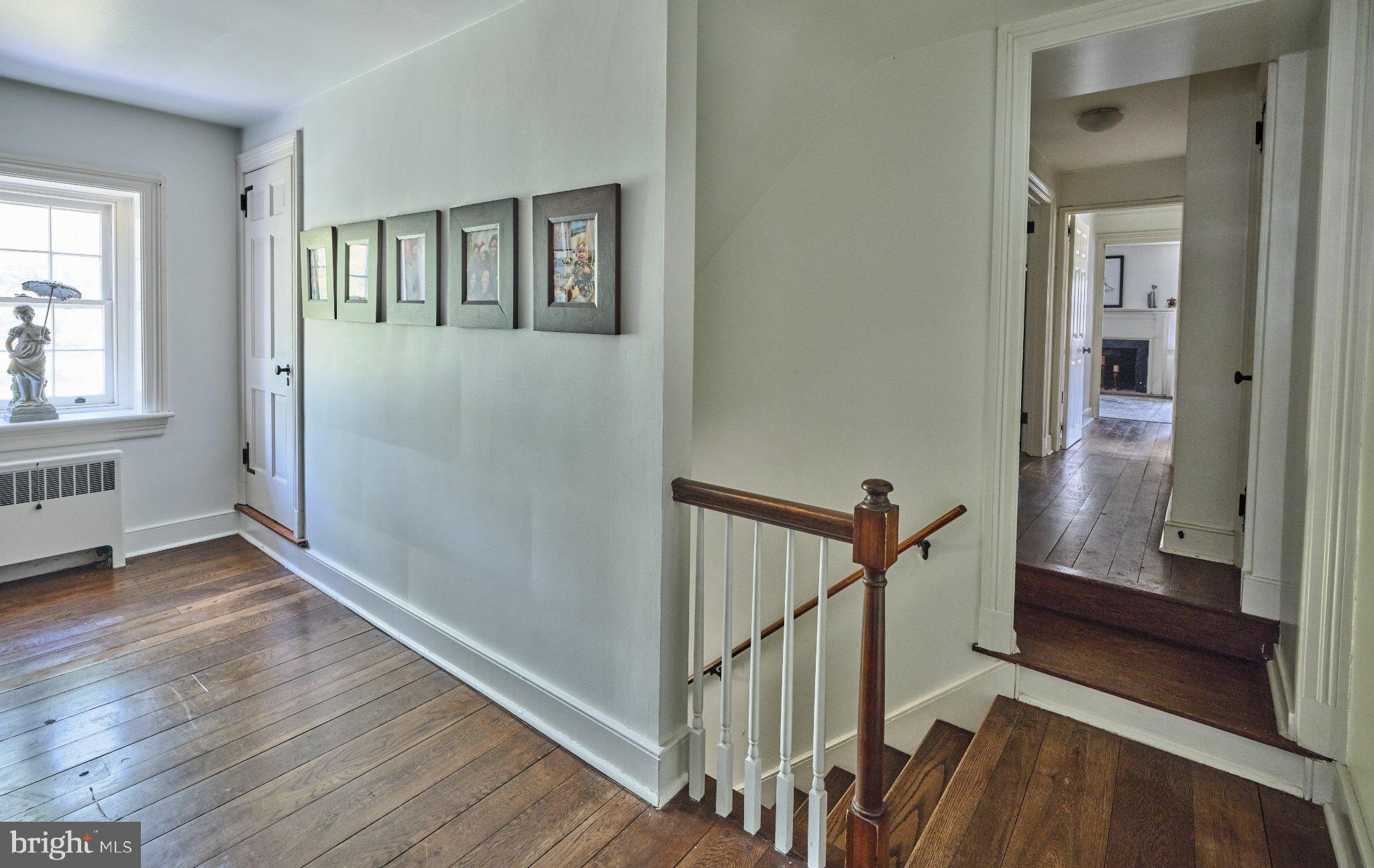 765 Swamp Road Newtown, PA 18940 - Photo 15 of 37 a view of a livingroom with wooden floor and stairs