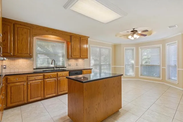 a kitchen with granite countertop a sink and a stove