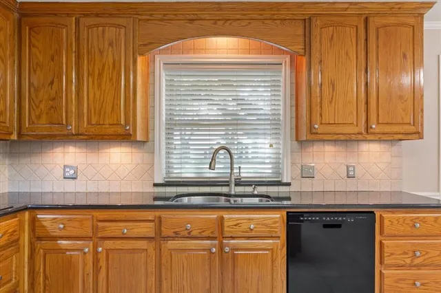 a kitchen with stainless steel appliances granite countertop cabinets and window