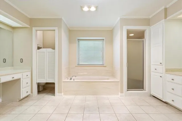 a spacious bathroom with a mirror and a bathtub