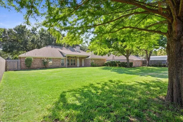 a front view of house with a garden