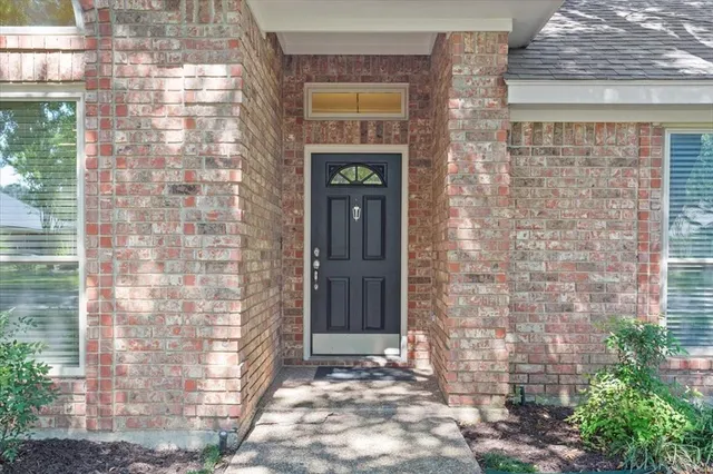 a front view of a brick house with many windows