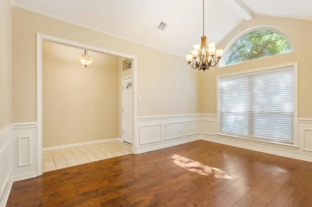 an empty room with windows and entrance