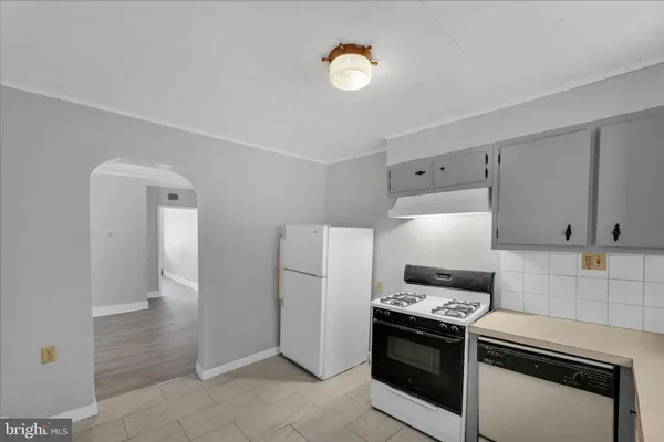 a kitchen with stainless steel appliances a stove a refrigerator and cabinets