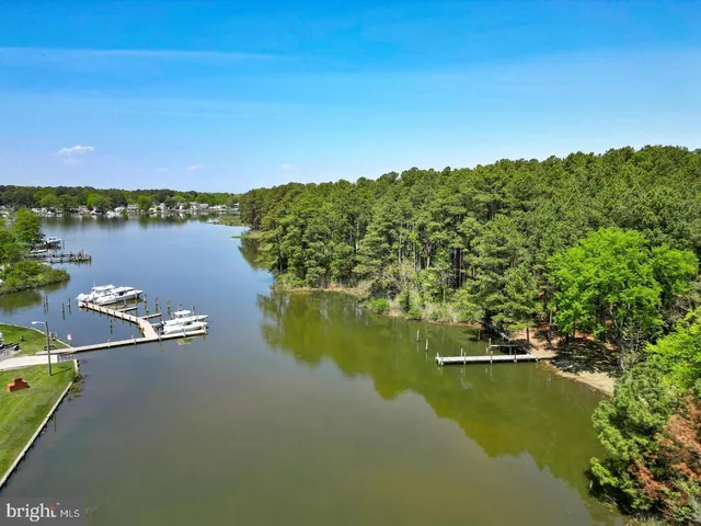 a view of a lake with lawn chairs