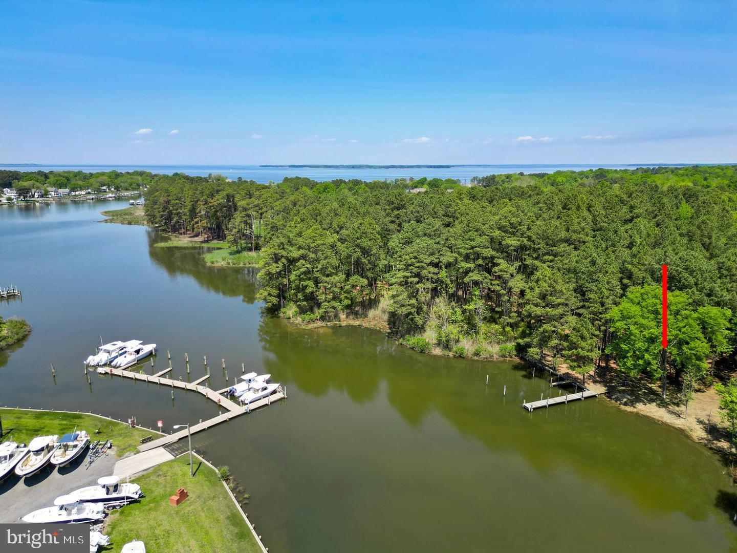 715 Winchester Creek Road Grasonville, MD 21638 - Photo 15 of 19 a view of a lake with lawn chairs