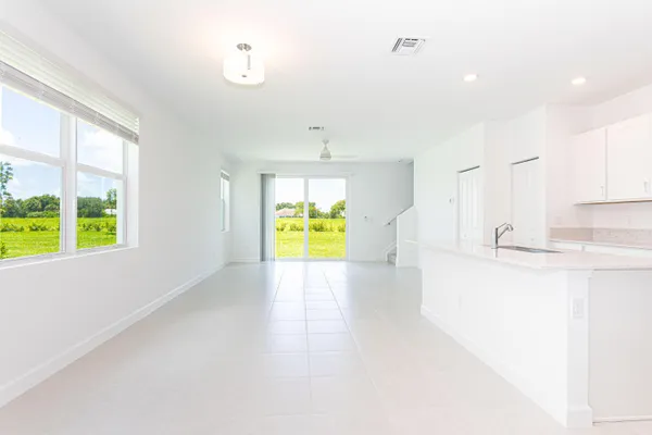 a view of a kitchen with wooden floor and a window