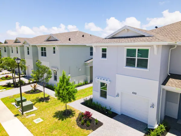a view of a house with swimming pool and sitting area
