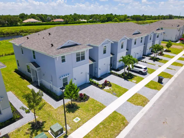 an aerial view of a house with a garden and swimming pool