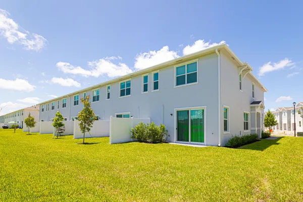 a view of pool house with yard and outdoor seating