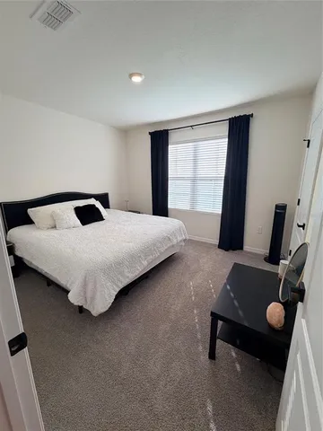 a bedroom with a bed and with furniture