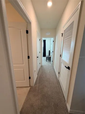 a view of a hallway with a white walls