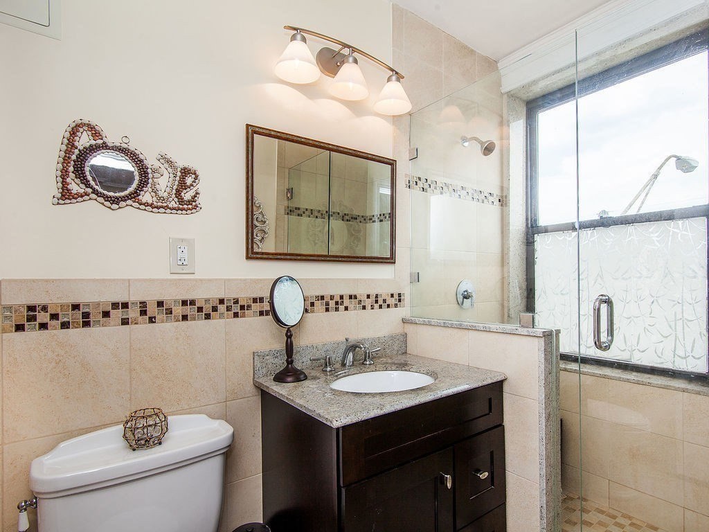 464 Commonwealth Avenue, Unit 36 Boston, MA 02215 - Photo 8 of 22 a bathroom with a sink and a mirror