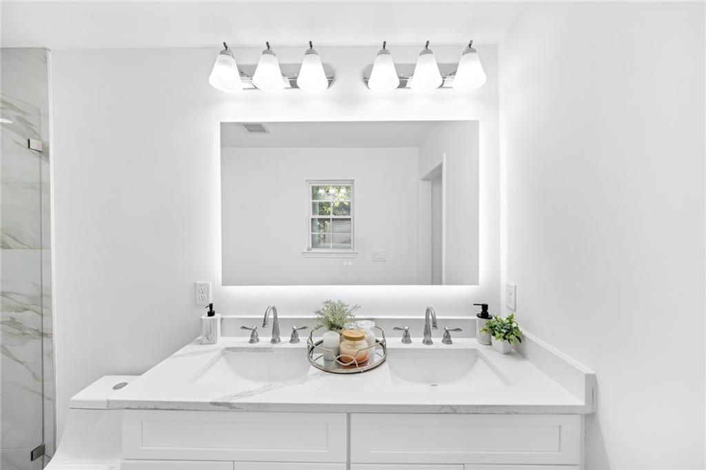 3892 Northstrand Drive Decatur, GA 30035 - Photo 13 of 25 a bathroom with a sink and a mirror