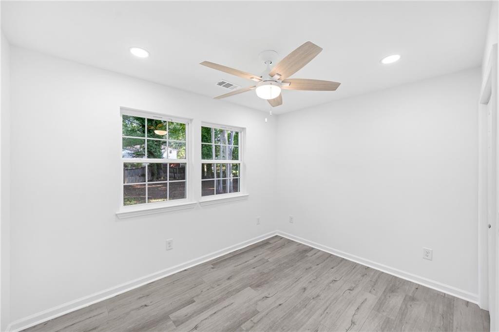 3892 Northstrand Drive Decatur, GA 30035 - Photo 17 of 25 an empty room with wooden floor and windows