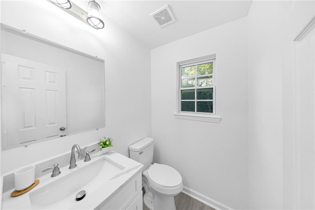 3892 Northstrand Drive Decatur, GA 30035 - Photo 18 of 25 a bathroom with a sink mirror toilet and next to a window
