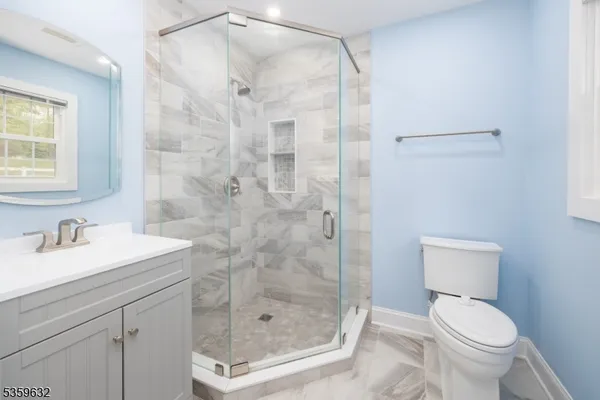 a bathroom with a shower a toilet and sink