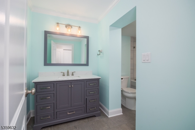 1625 Highway 206 Chester, NJ 07930 - Photo 23 of 46 a bathroom with a toilet a sink and mirror