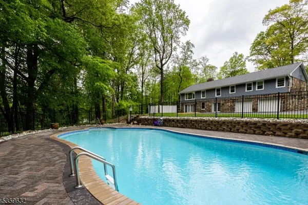 a view of a house with pool and sitting area
