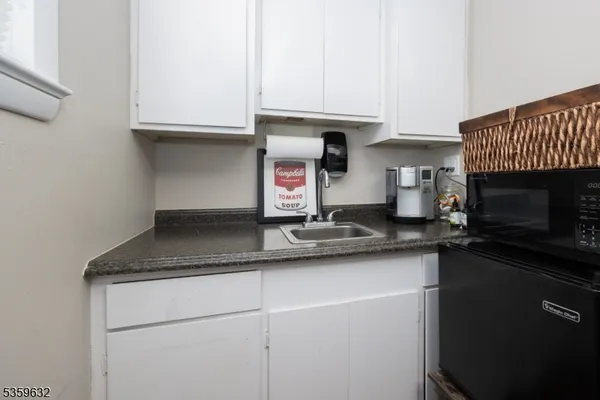 a kitchen with stainless steel appliances granite countertop a sink a stove and a microwave
