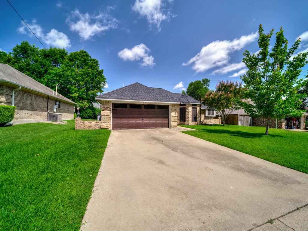 121 Northeast Brushy Mound Road Burleson, TX 76028 - Photo 2 of 35 a front view of a house with a yard and garage