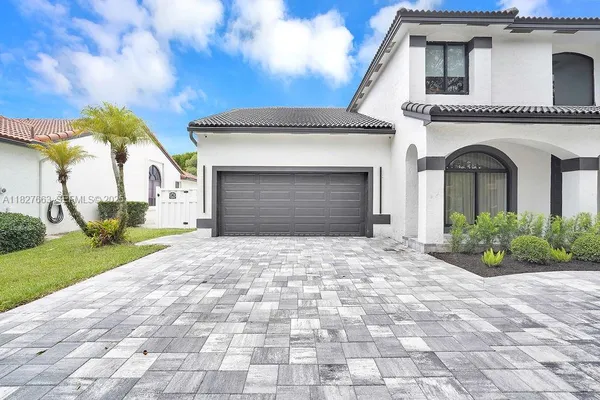a front view of a house with a yard and garage