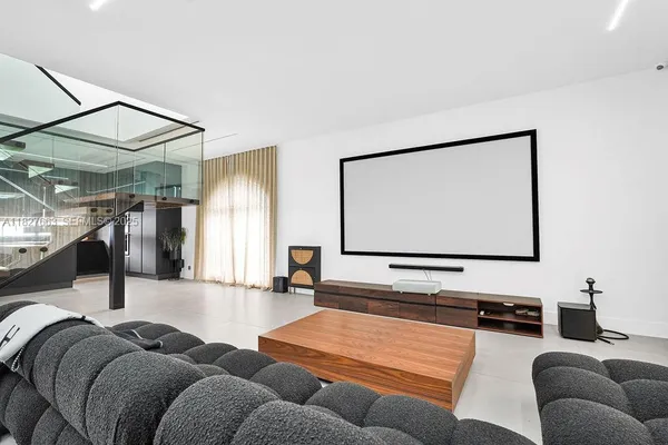 a living room with furniture projector and a window