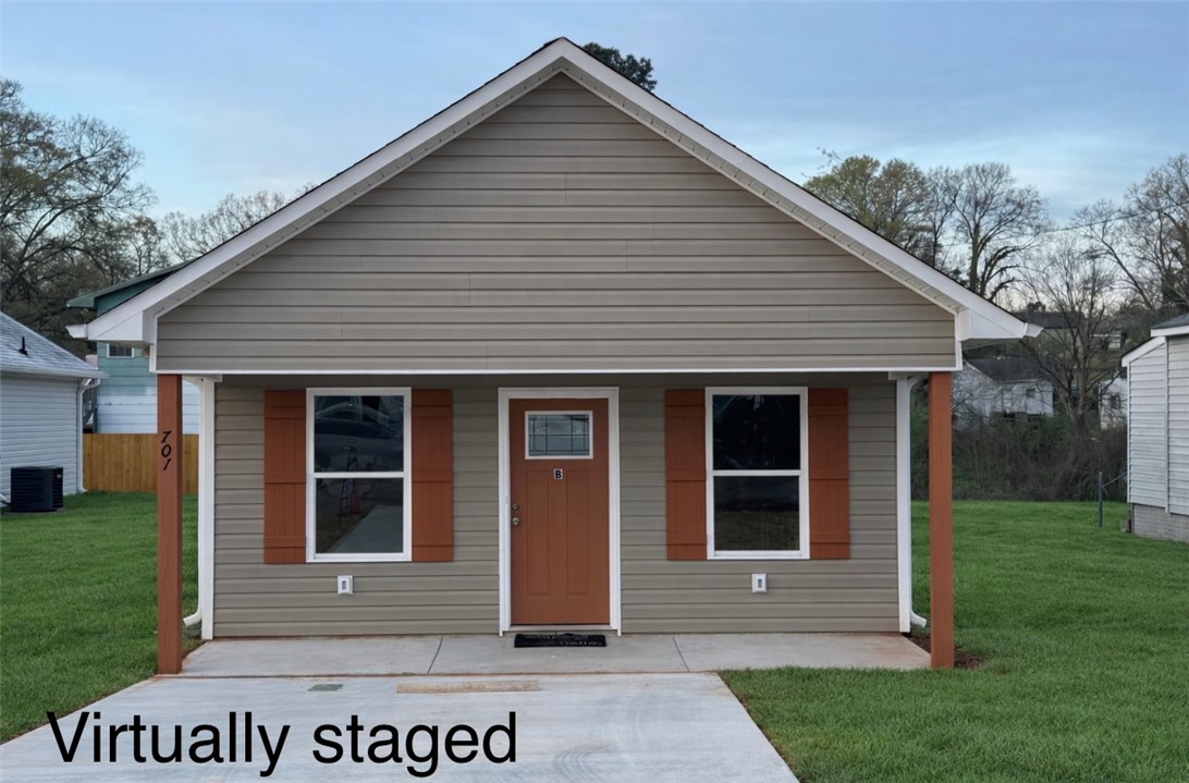 This charming home offers a cozy facade with inviting curb appeal.