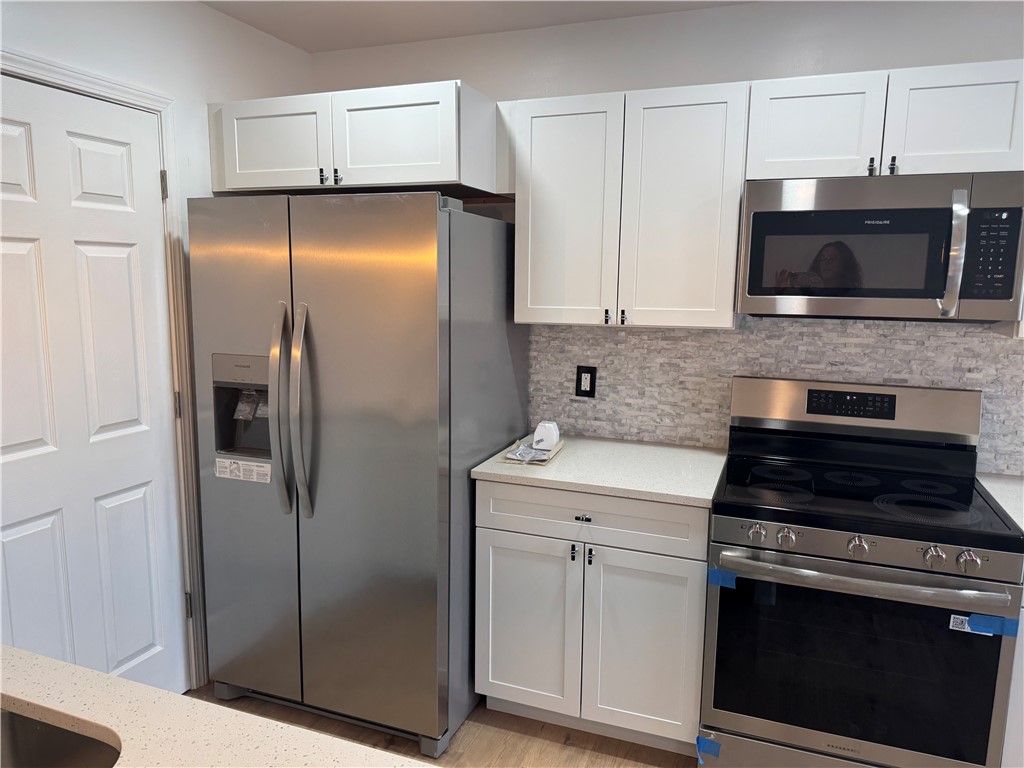 701 Delia Street, Unit B Anderson, SC 29624 - Photo 13 of 25 This modern kitchen features sleek appliances and ample storage, creating a functional culinary space.