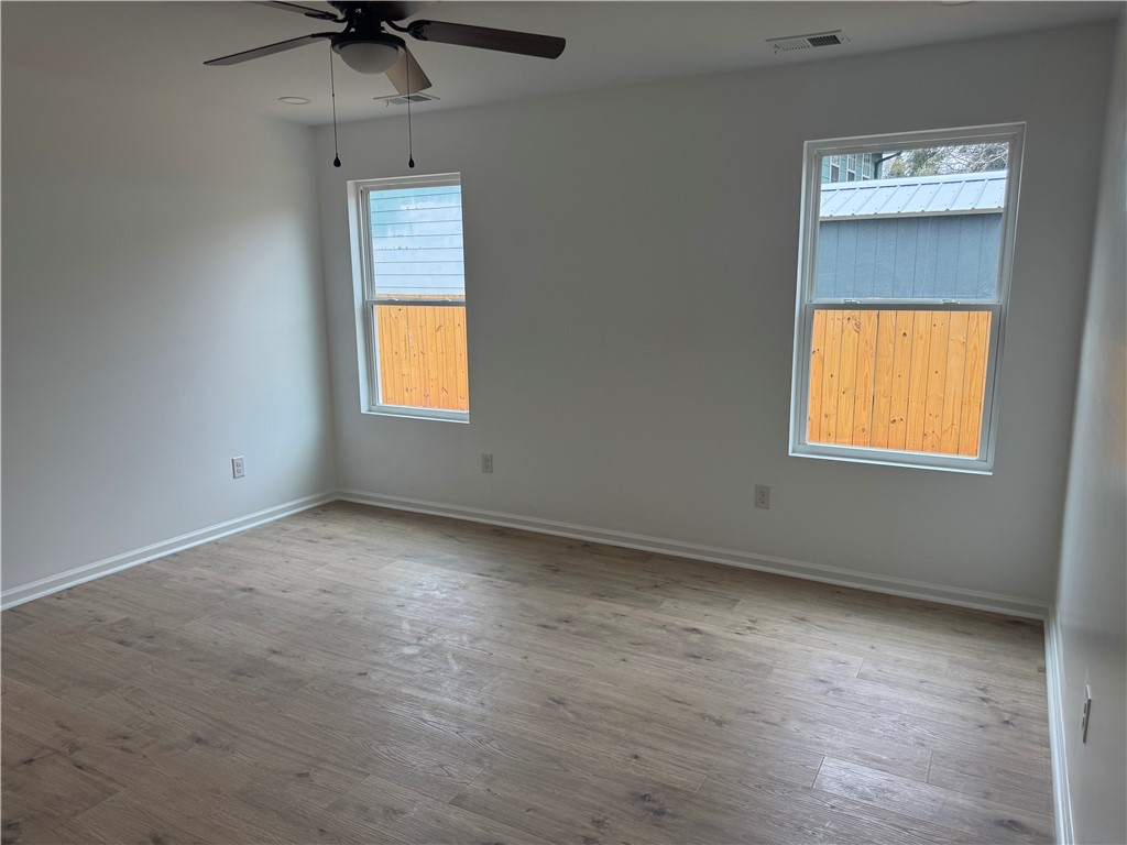 701 Delia Street, Unit B Anderson, SC 29624 - Photo 18 of 25 This bright and airy room features sleek flooring, offering a perfect blank canvas for your personal style.