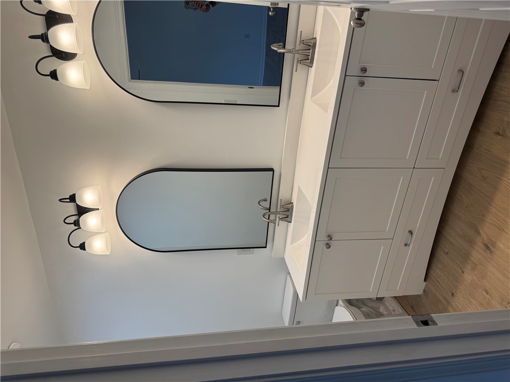 701 Delia Street, Unit B Anderson, SC 29624 - Photo 23 of 25 This bathroom features a double vanity, ample storage, and warm lighting, creating a bright and functional space.