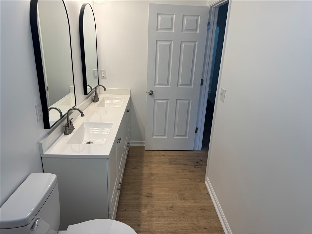 701 Delia Street, Unit B Anderson, SC 29624 - Photo 24 of 25 This bathroom features a double vanity and light wood flooring.