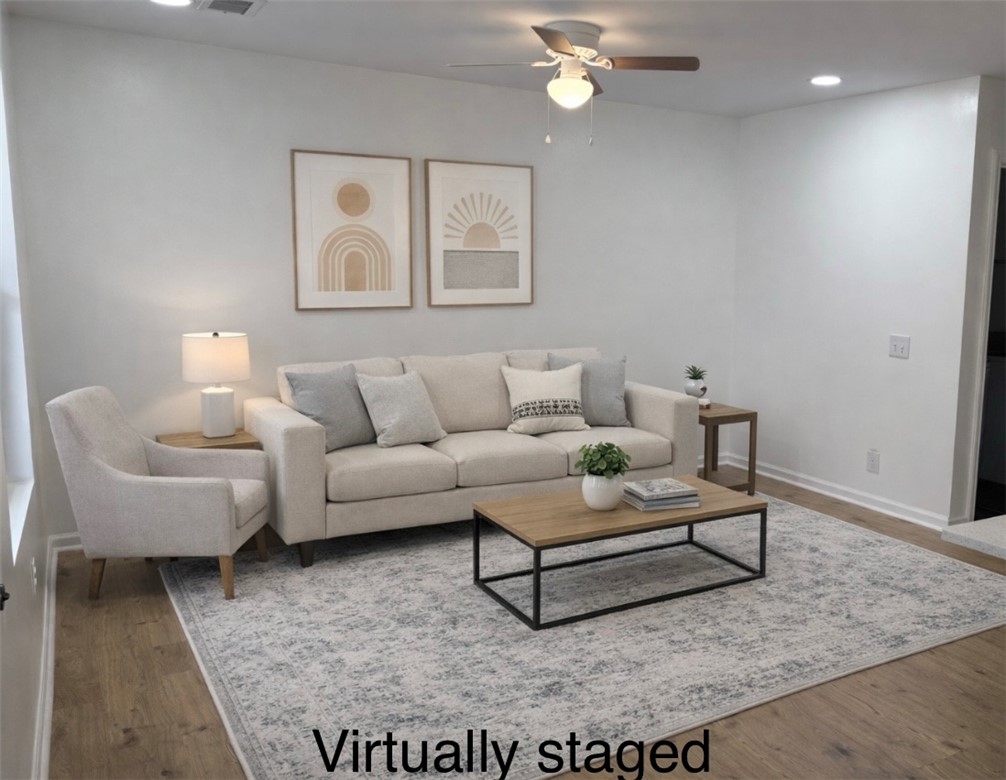 701 Delia Street, Unit B Anderson, SC 29624 - Photo 9 of 25 This inviting living room features warm flooring, creating a comfortable and welcoming atmosphere for all.