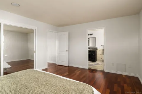a view of a livingroom with wooden floor and staircase