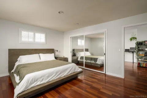 a bedroom with a bed and a mirror