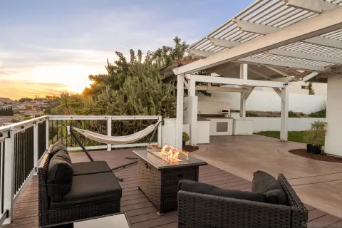 a view of a roof deck with couches and wooden floor