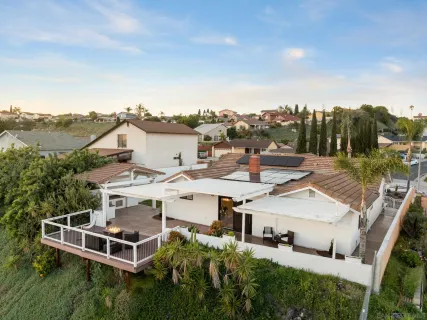 an aerial view of a house with a garden and trees