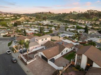 an aerial view of a house with a city view