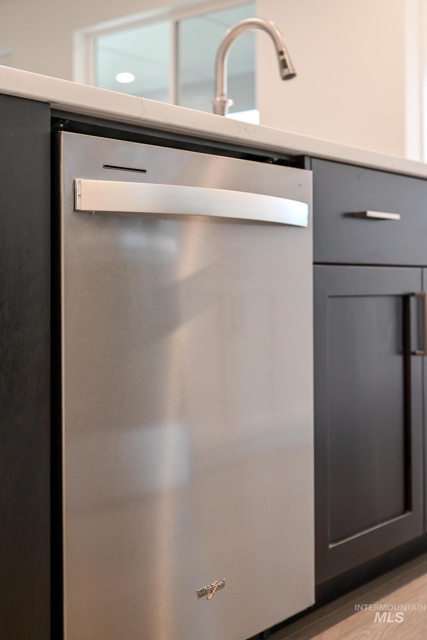 5923 West Snow Currant Street Meridian, ID 83646 - Photo 12 of 28 Kitchen view of stainless steel dishwasher, gray cabinets, and light wood finished floors