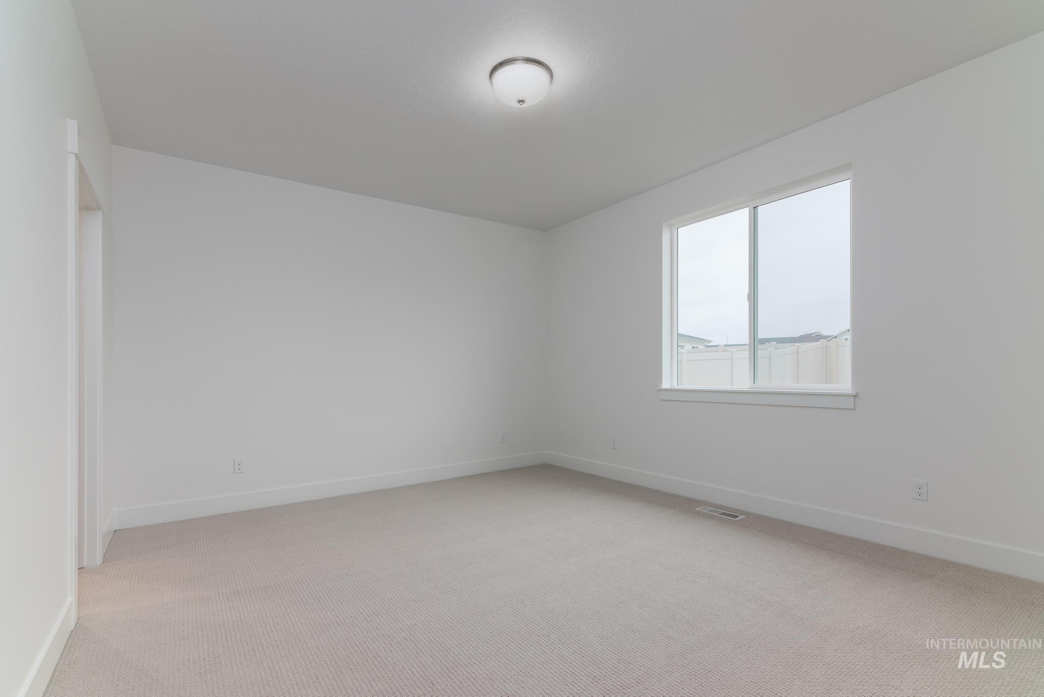 5923 West Snow Currant Street Meridian, ID 83646 - Photo 17 of 28 Unfurnished room with light colored carpet and baseboards