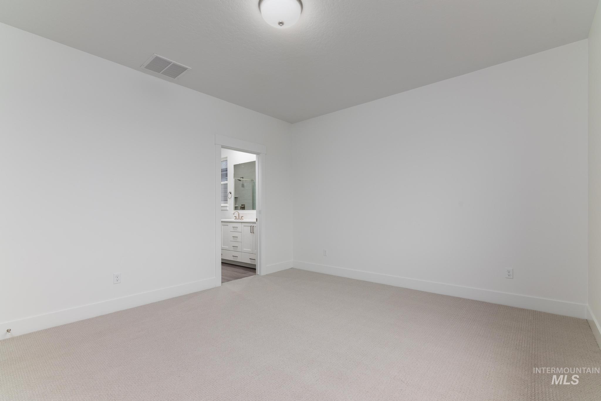 5923 West Snow Currant Street Meridian, ID 83646 - Photo 18 of 28 Unfurnished bedroom featuring light colored carpet and ensuite bath