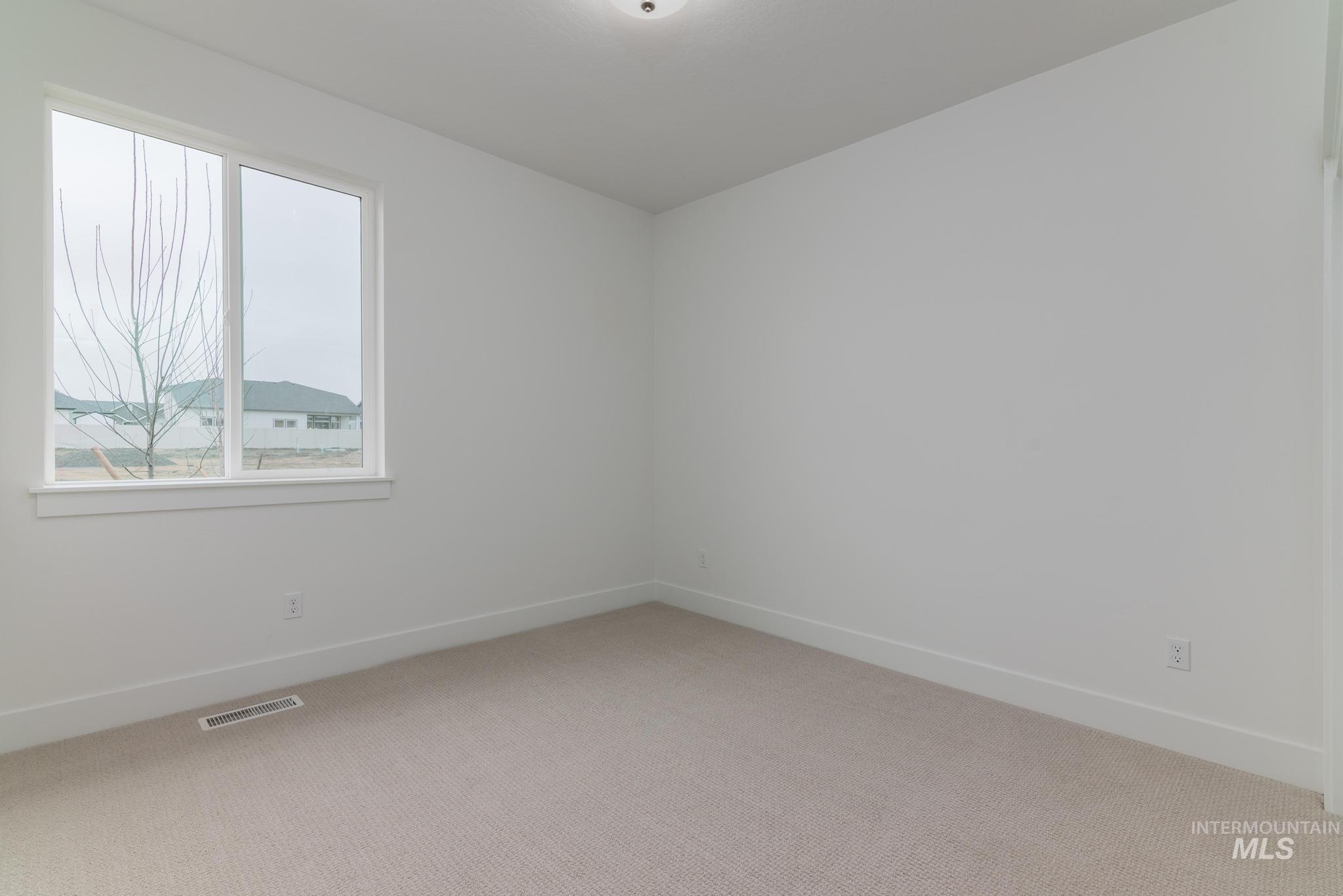 5923 West Snow Currant Street Meridian, ID 83646 - Photo 21 of 28 Empty room featuring light carpet and baseboards