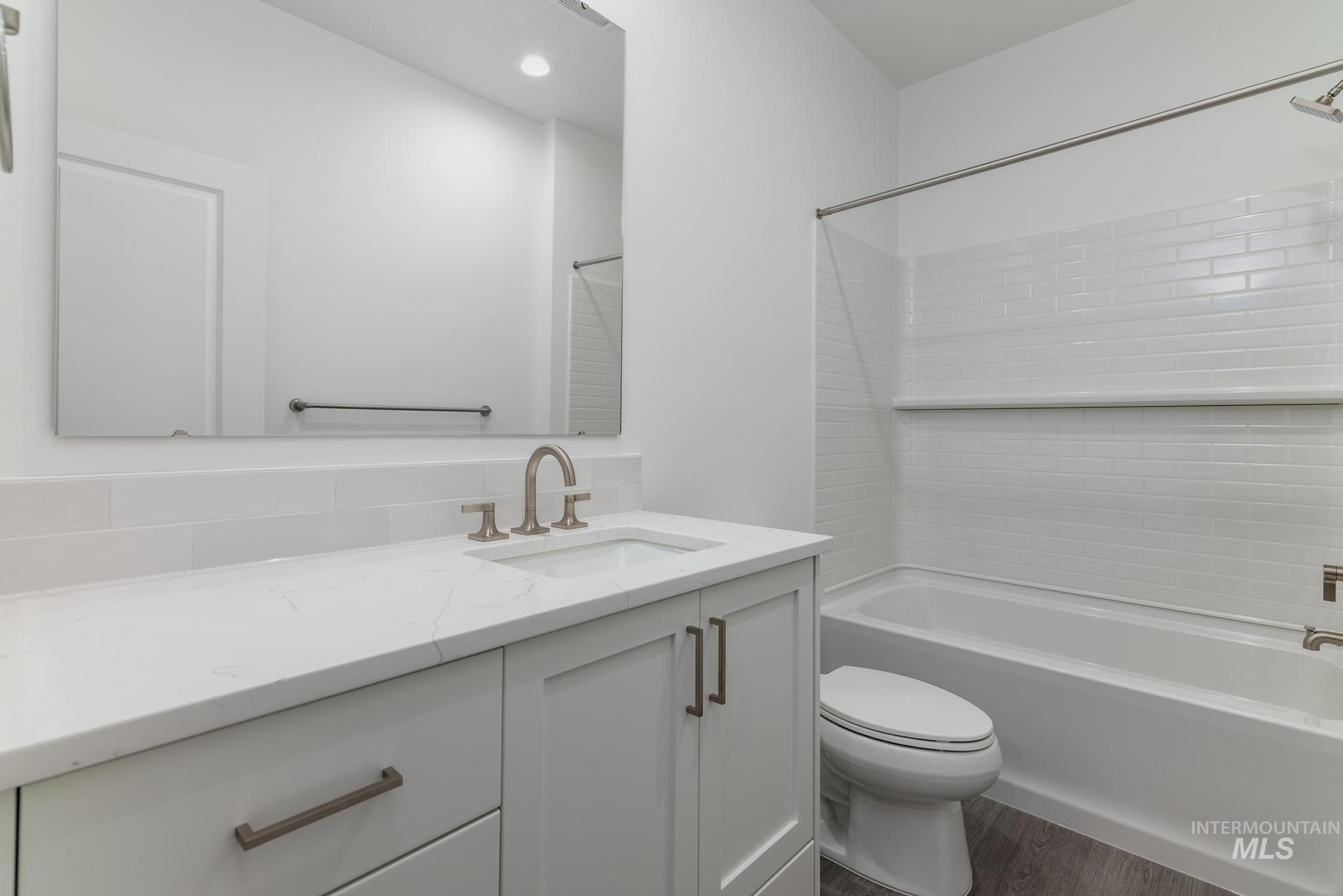 5923 West Snow Currant Street Meridian, ID 83646 - Photo 22 of 28 Full bathroom featuring vanity, bathtub / shower combination, dark wood finished floors, and recessed lighting