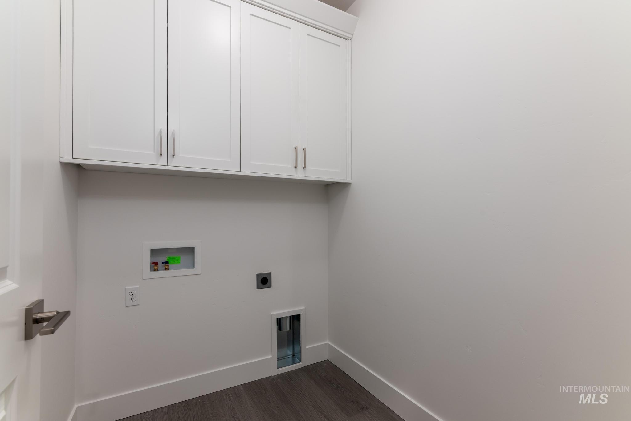 5923 West Snow Currant Street Meridian, ID 83646 - Photo 23 of 28 Laundry room featuring electric dryer hookup, dark wood-style floors, washer hookup, and cabinet space