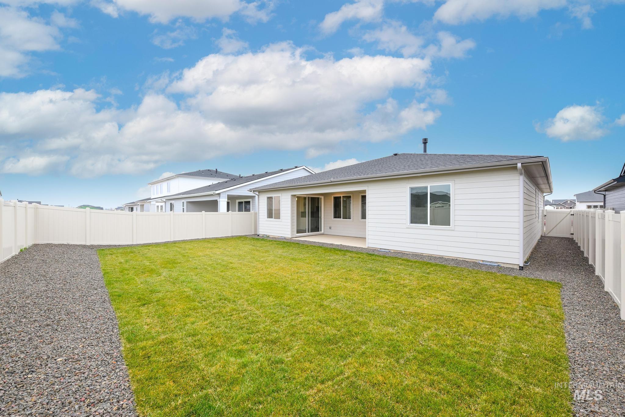 5923 West Snow Currant Street Meridian, ID 83646 - Photo 25 of 28 Back of house with a patio area and a fenced backyard
