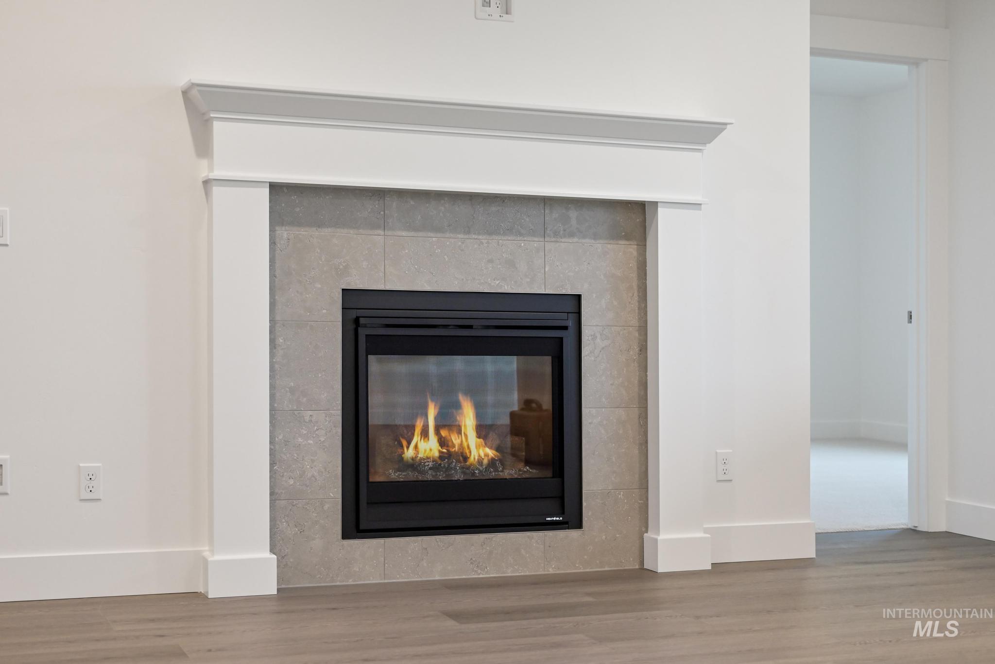 5923 West Snow Currant Street Meridian, ID 83646 - Photo 6 of 28 Detailed view of wood finished floors and a tile fireplace