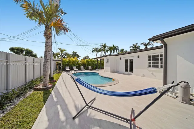 a view of a backyard with potted plants